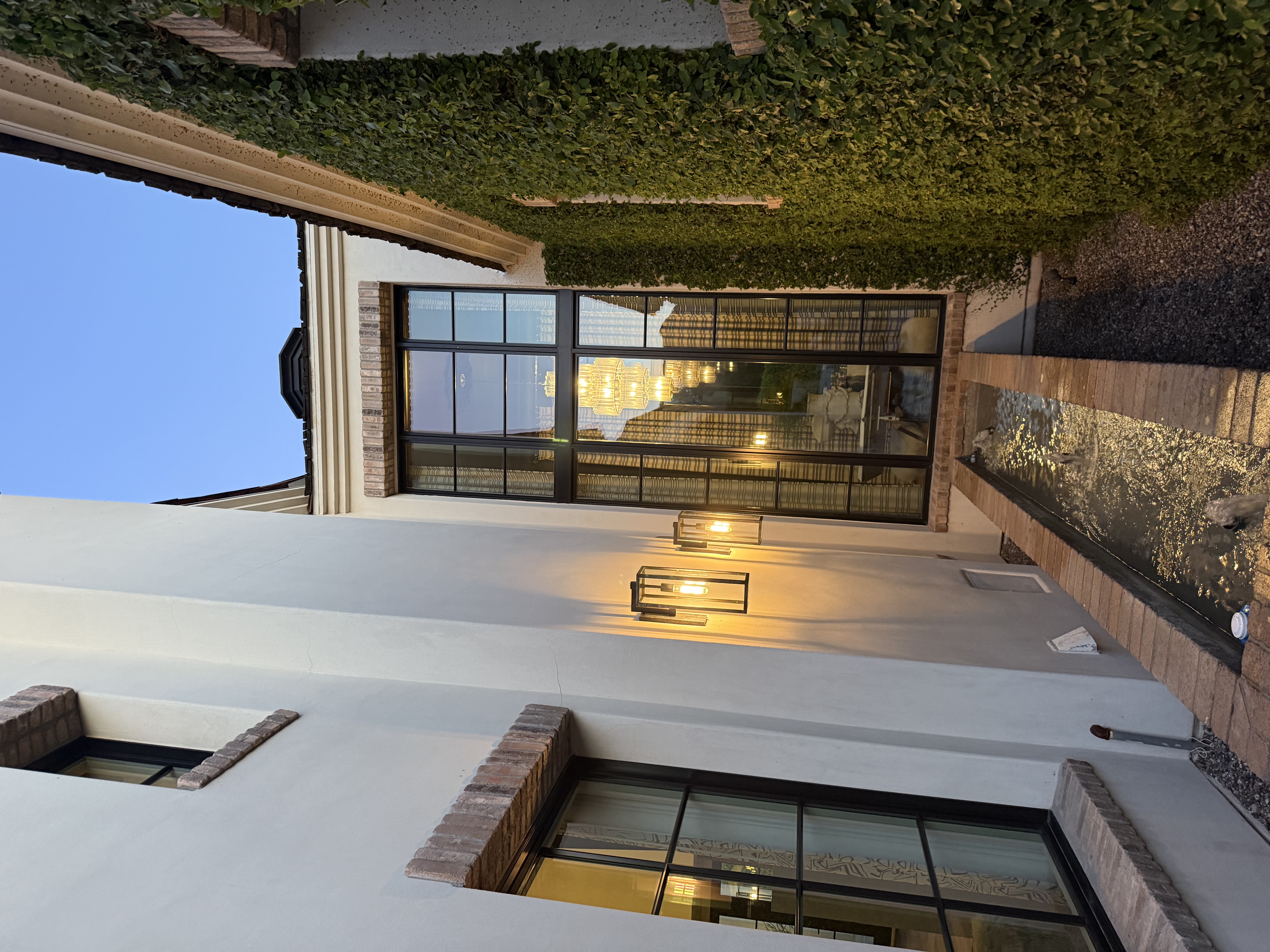 Floor-to-ceiling windows and exterior lights at dusk