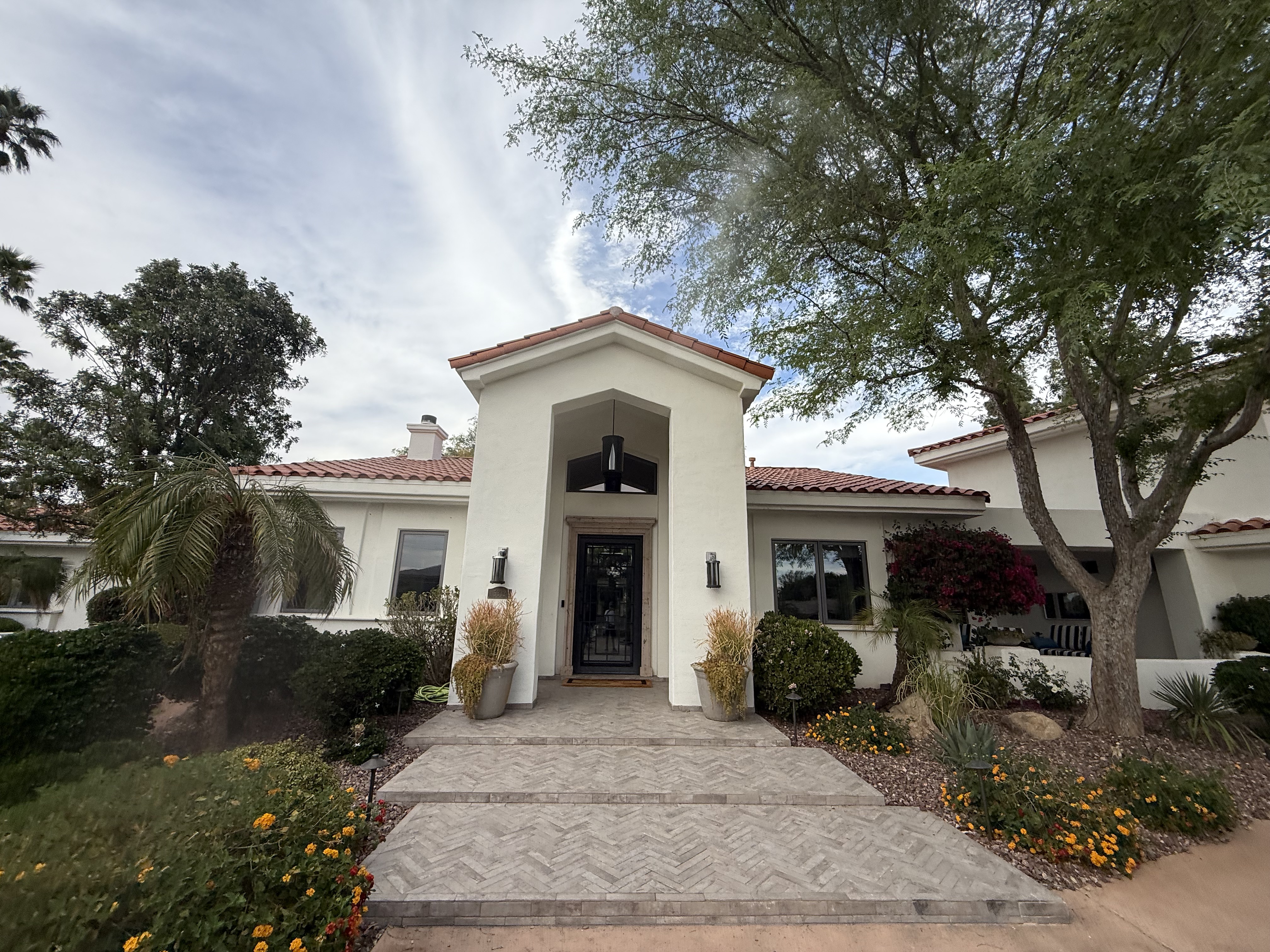 Mediterranean home with tile roof and herringbone pavers