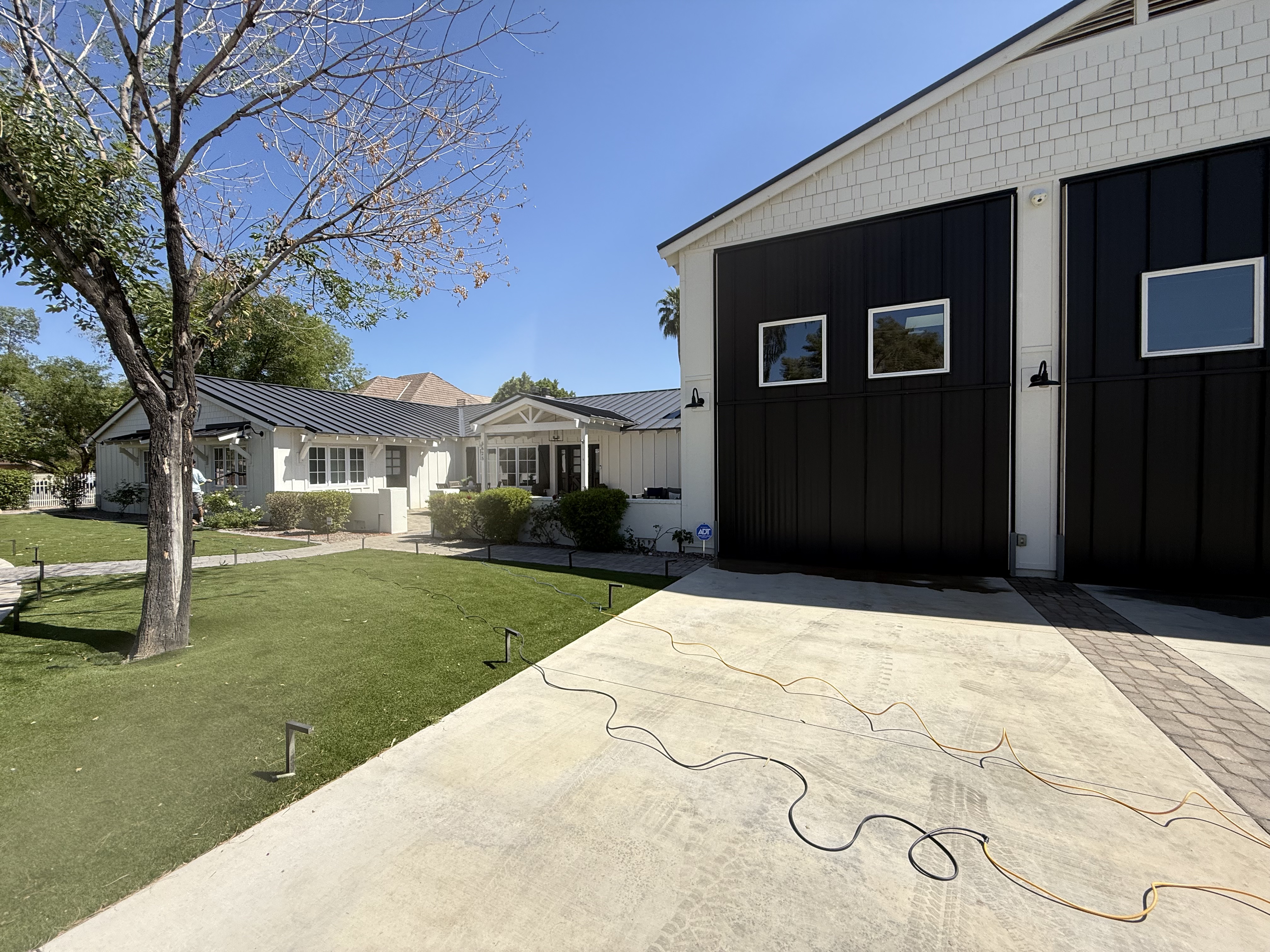 Concrete driveway cleaning on modern farmhouse property