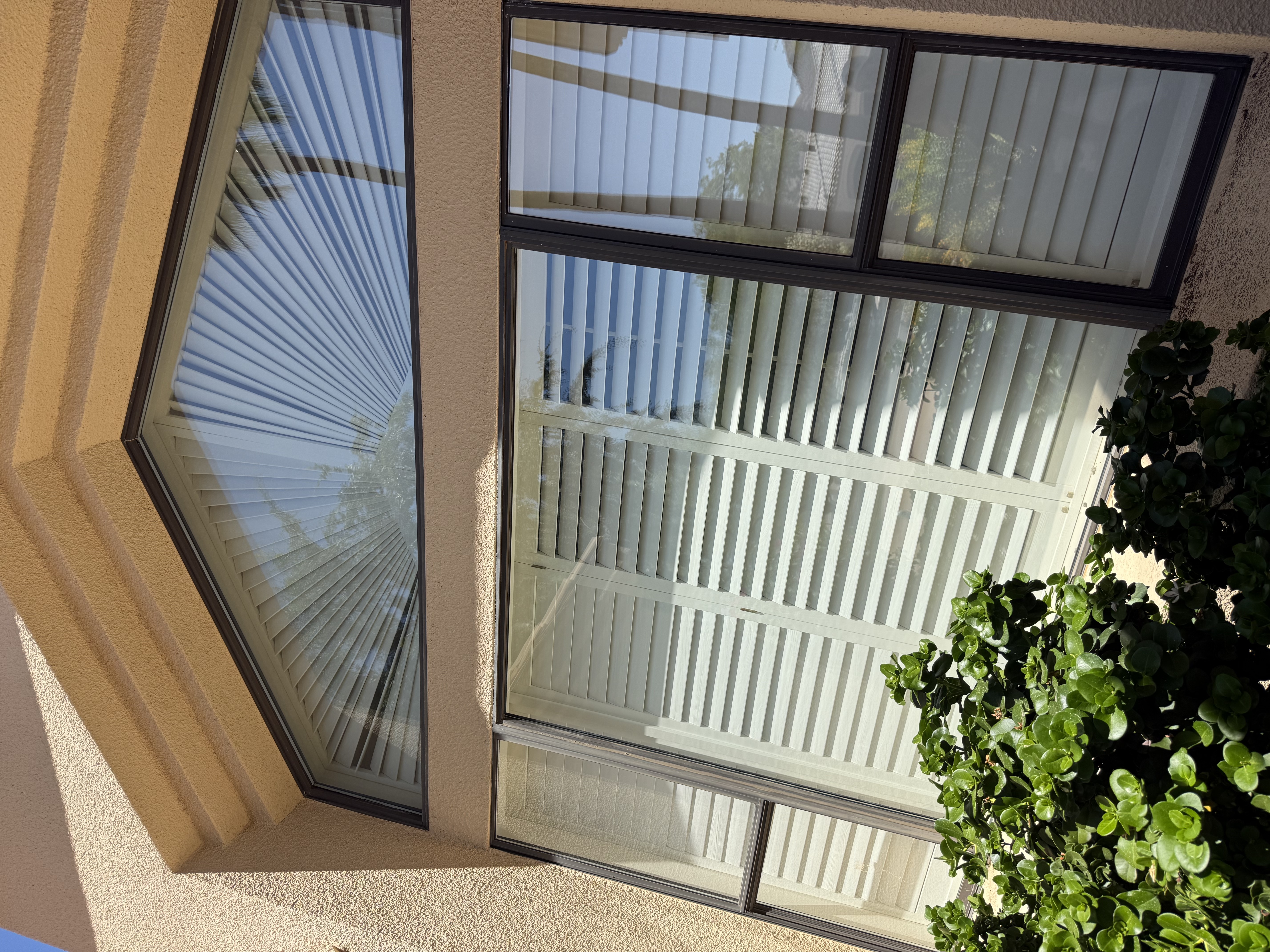 Arch fan window cleaned streak-free on stucco home