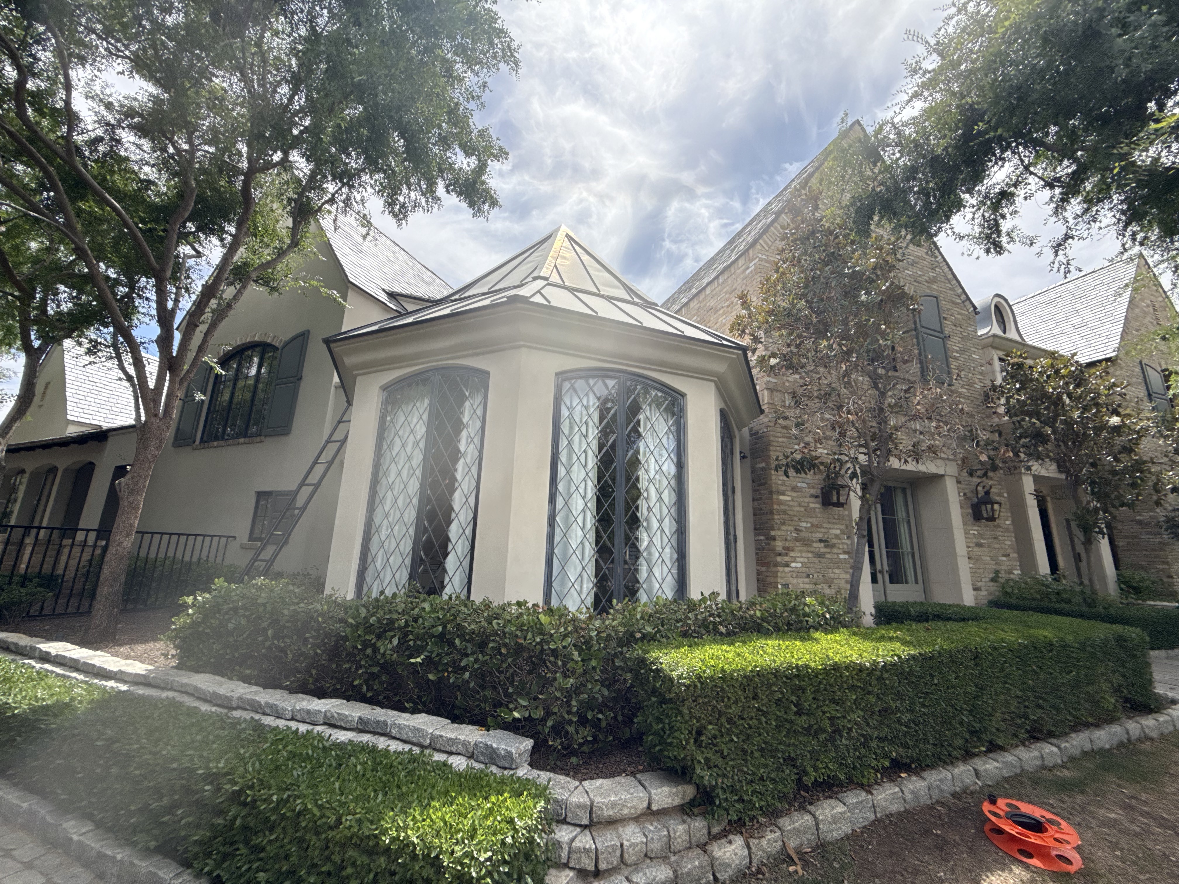 Curved lattice windows on estate home — after cleaning