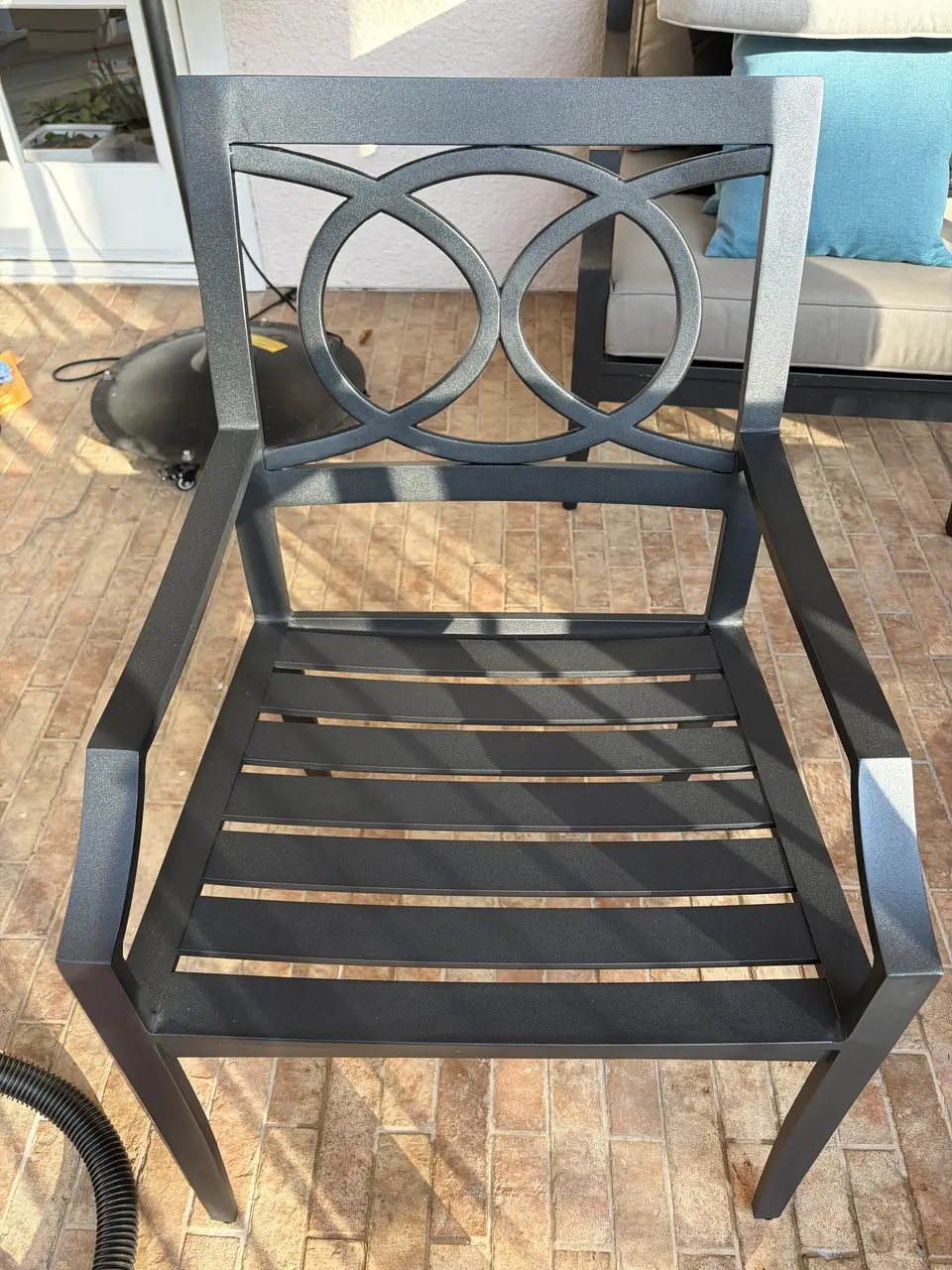 Metal outdoor chair with an even dark surface