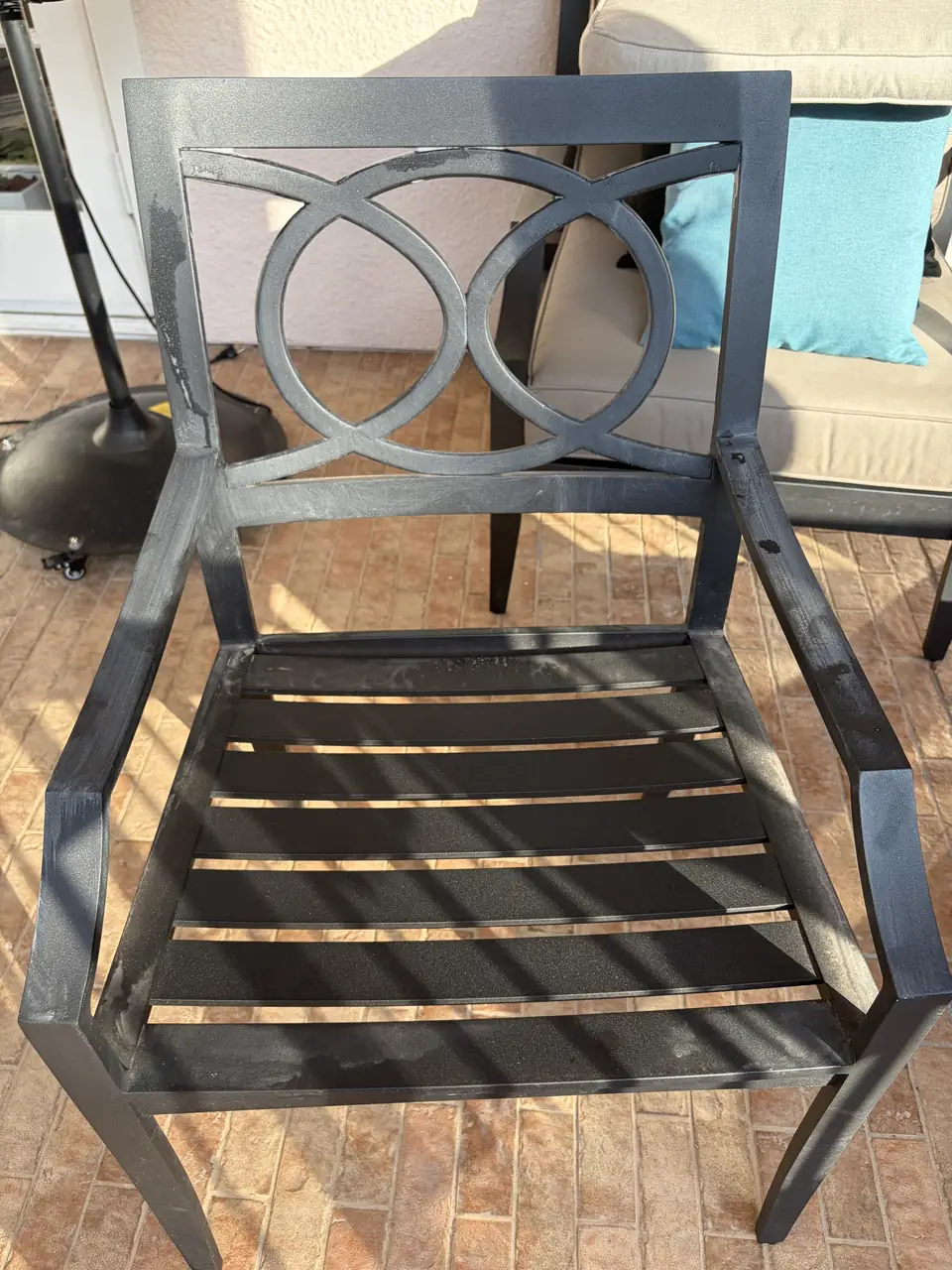 Metal outdoor chair with visible surface residue