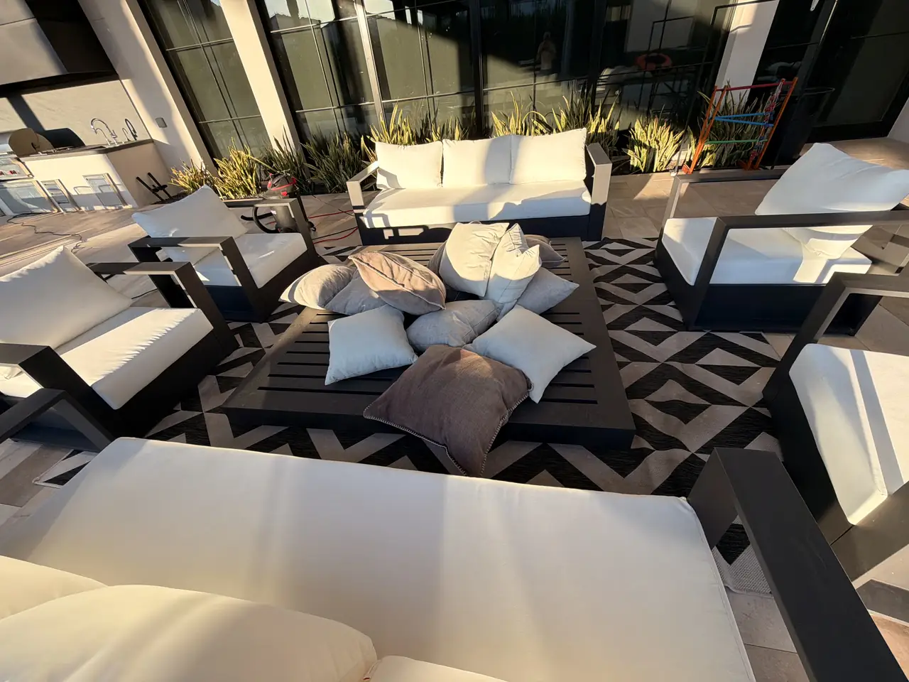 Outdoor cushions arranged around patio furniture